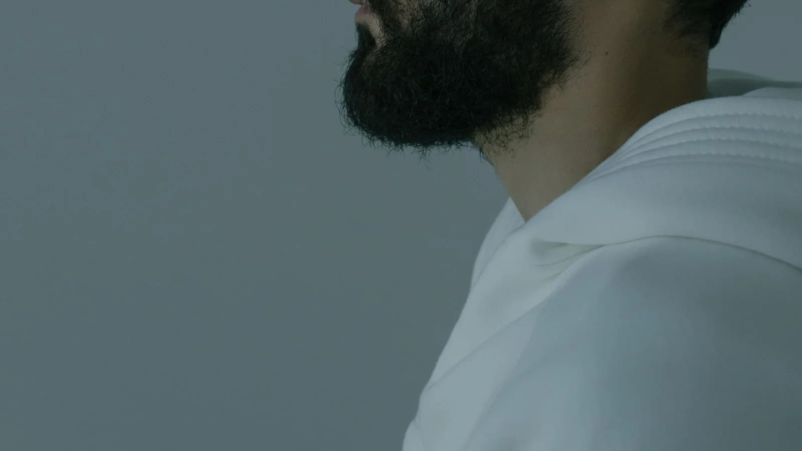 Side profile of a man with 'CYBER SECURITY' projected on his face, emphasizing digital security themes.