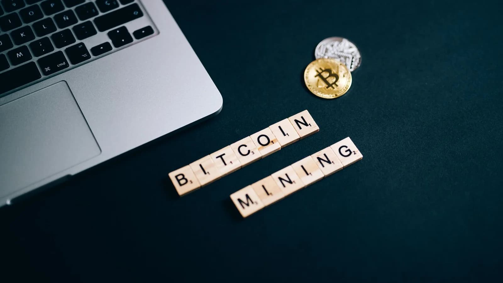 Bitcoin mining concept with a laptop keyboard and letter tiles