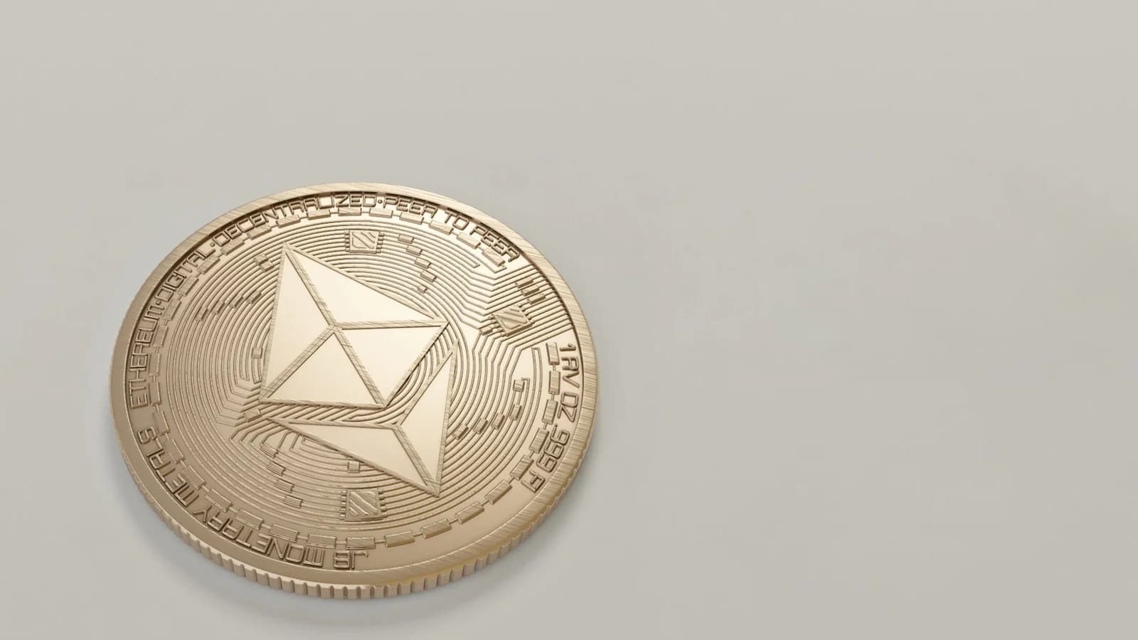 Golden Ethereum coin on a light background