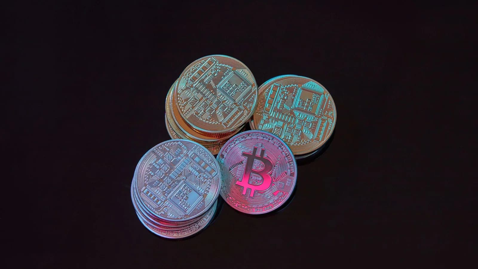 A detailed image showcasing a stack of Bitcoin cryptocurrency coins on a black background.